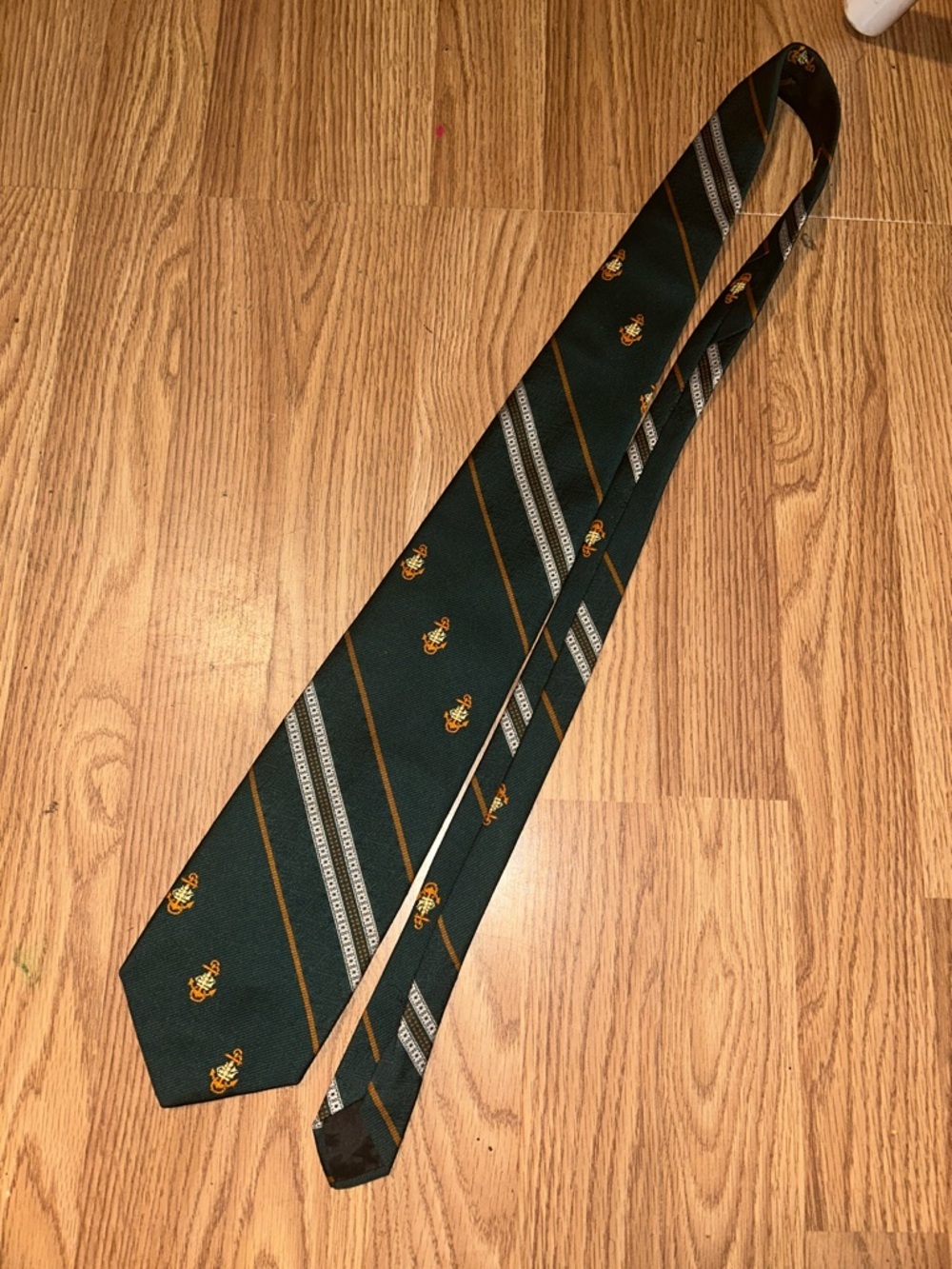 Dark Green Striped Men's Tie with Gold Crest Accent